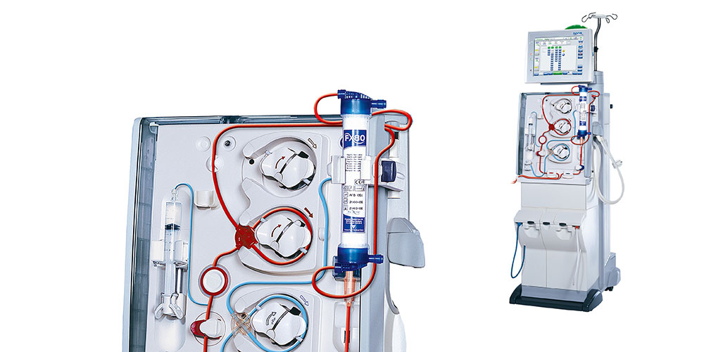 Detailed view of a modern hemodialysis machine setup showing internal and external components, with pipes, dials, and a digital monitor for patient monitoring.